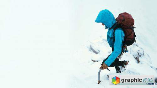 Mountaineer using an ice axe to climb Forcan Ridge in Glen Shiel, Scotland